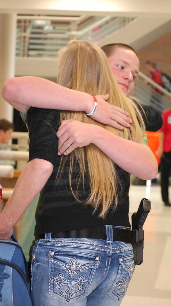 A Lewis-Palmer student hugging Marshall.