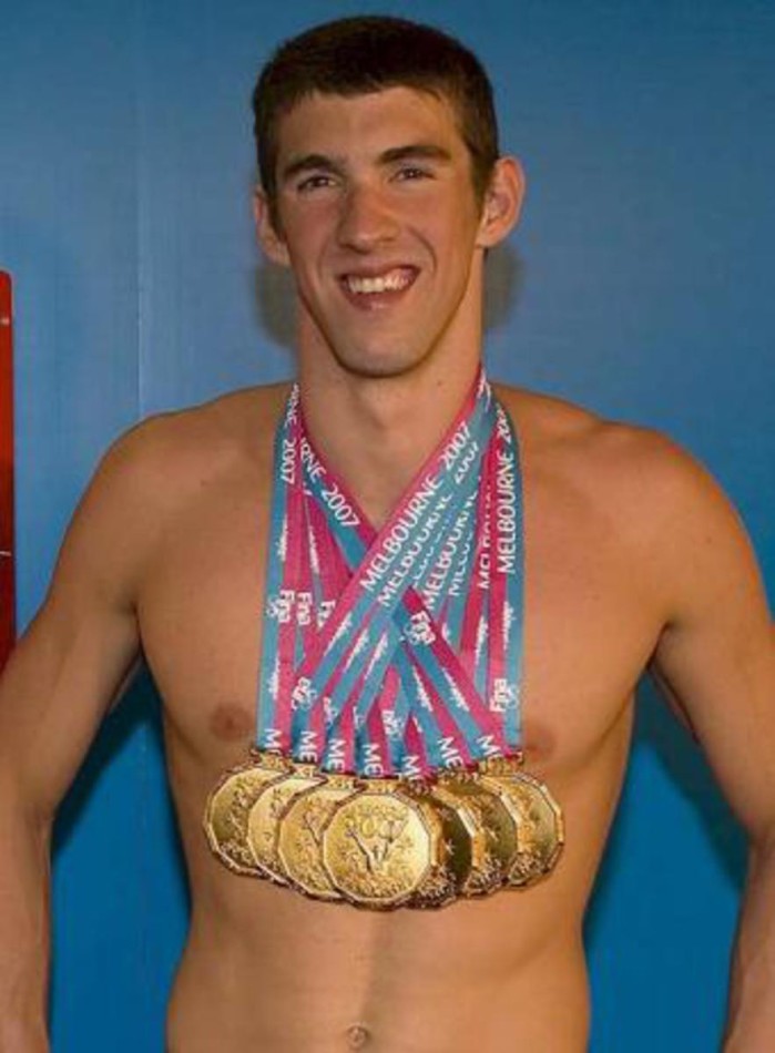 Michael Phelps wearing a few of his many medals.