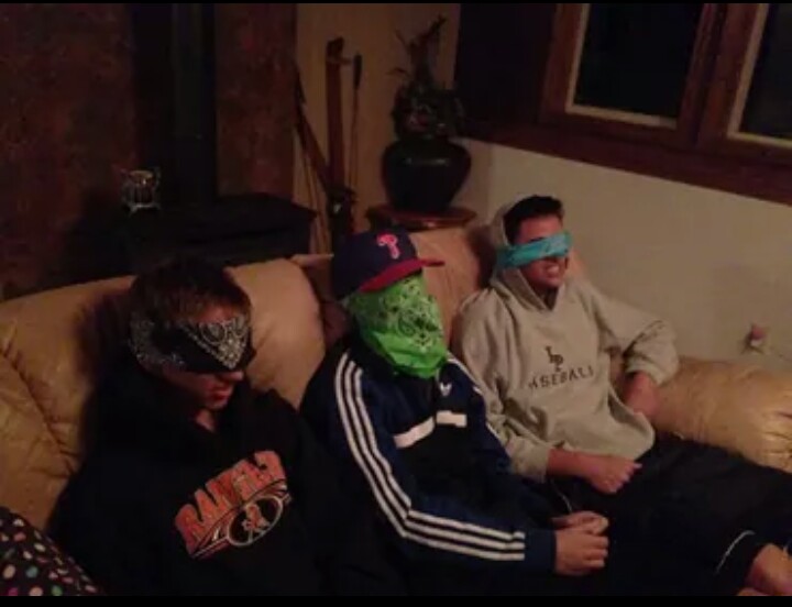 Jeffrey Naumiec, Bryce Herndon, and Ethan Liss sit blindfolded on a couch during the night of SWAG, awaiting the reveal of their costumes.