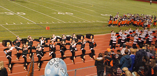 The cheer and poms teams line up for a performance during the last football game of the season