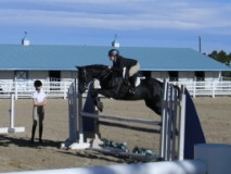 Amy Cooper jumps one of her horses at a competition.