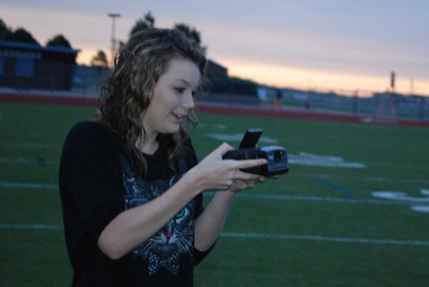 Snapping and printing candid shots, Aeryn Kiewicz  excites her passion on the football field during last falls Senior Sunrise.