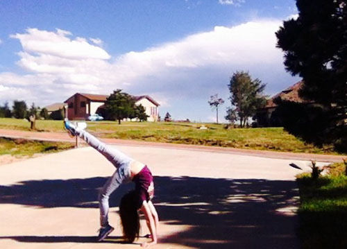 Hannah Rollins takes a screen-shot of her acrobatics skills from gymnastics in her driveway.