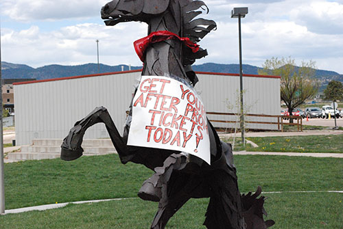 The ranger statue in front of Lewis-Palmer advertises after prom.