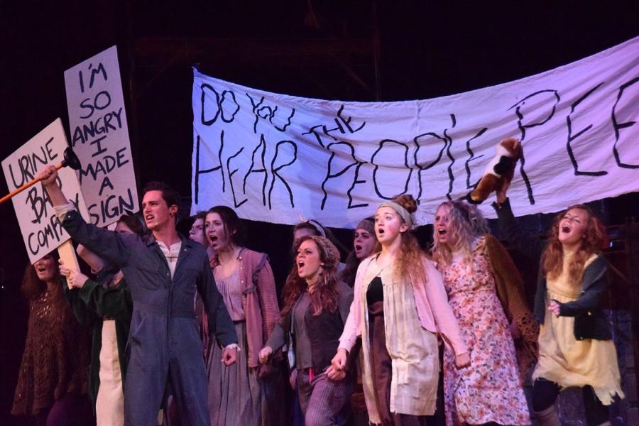 The+cast+of+Urinetown+marches+to+the+music+on+the+last+number+before+the+intermission.+