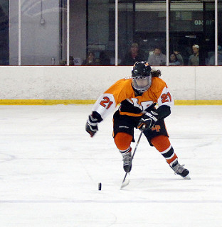 Kamren Shoup, number 21, skating to make a goal. 