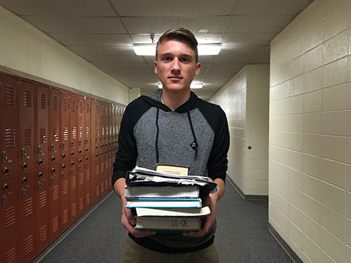 Jacob Larson, 9, carrying his heavy weight of books for his high school classes.