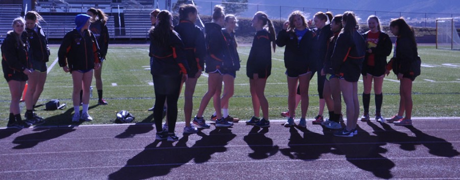 The Lewis-Palmer Girls track team meets on the field before the daily anouncments.