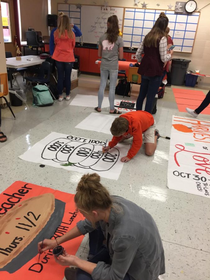 Student Council members design posters for Harvest of Love.