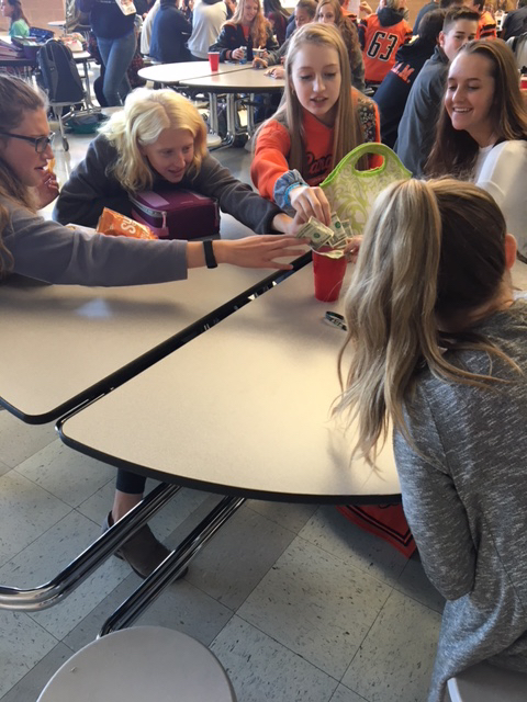 Students donate money during a Miracle Minute.