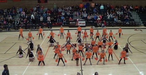 The girls who attended the kids clinic, perform at a boys basketball game. 