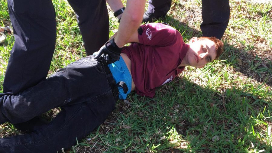 Nikolas Cruz being arrested after police find him walking through a residential area. 