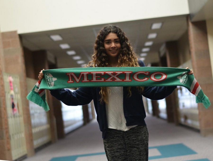 Garcia holds up a banner of Mexico honoring her home country. “It was hard to leave my family and friends, but I can always visit them soon,” Garcia said.