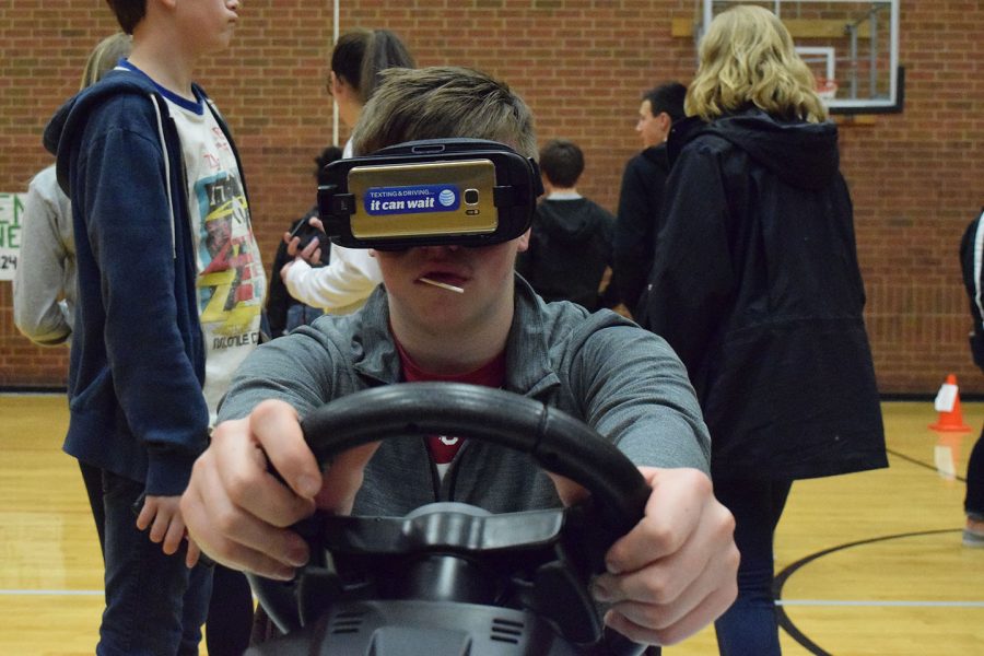 Alex Weaver 11 attempts a driving course while wearing under the influence goggles. 