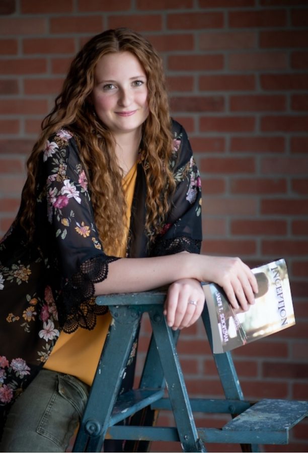 Jaidyn Schortzman poses with her book Inception. Writing for me is kind of an escape into my own world where I control whats going on, and I know whats going to happen next,” Jaidyn Schortzman 12 said.