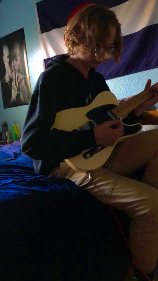 Eyer sits on his bed and plays the guitar. Sometimes it can be difficult to make music because a lot of different people have different ideas in their heads,” Eyer said. “So if everyone’s not on the same page, it can be extremely difficult to make music.”