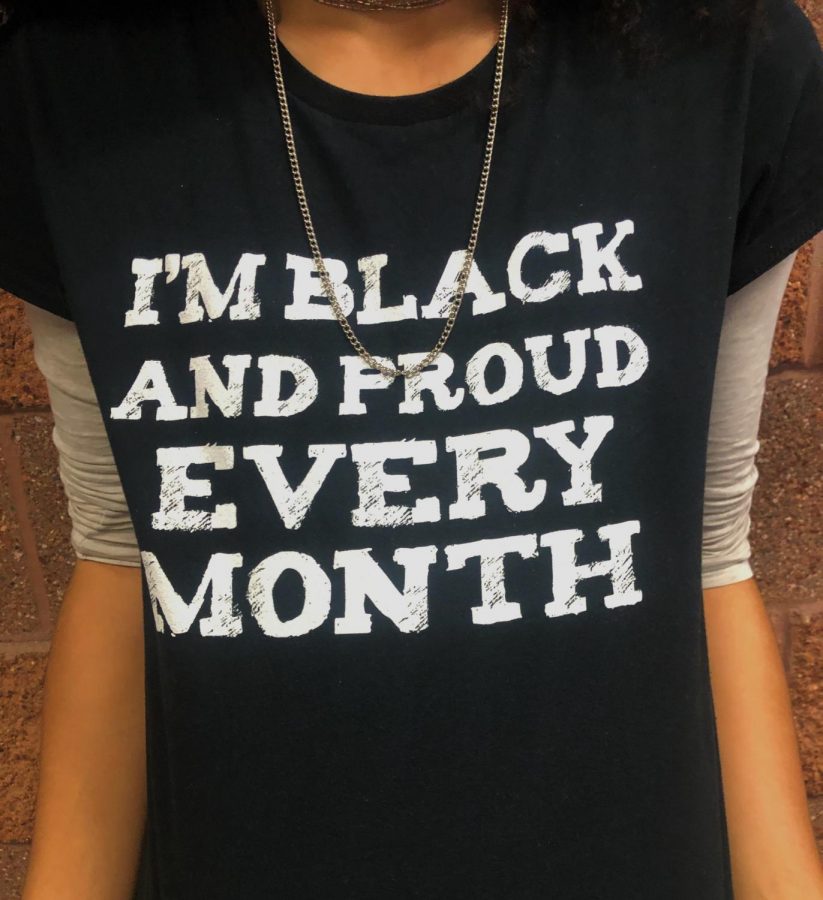 Kinser poses while wearing her “I’m black and proud every month” shirt to communicate her opinions about Black History Month. “After my experiences, I got tougher and I knew that the kids here were not going to be nice, no matter what. I feel that it is still hard to talk to people; its a subject here at Lewis-Palmer that even makes the adults skirm in their seats over something that happens to you,” Kinser said.
