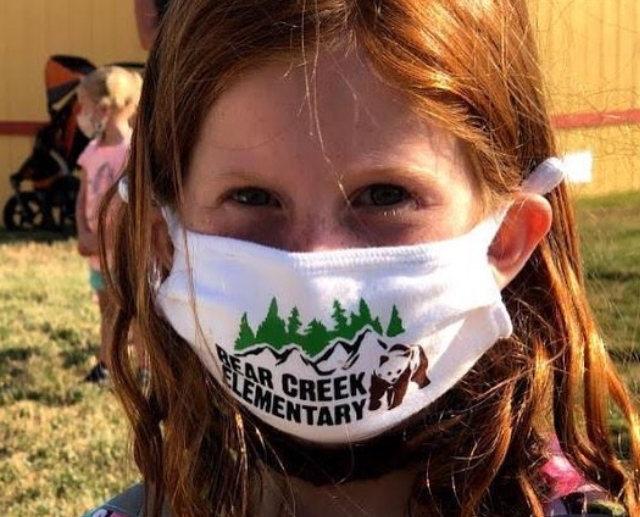 Student wears mask while entering school. 
Photo Credits to Lewis-Palmer School District