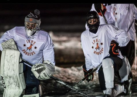 Cameron Hurt 12 (Left), and Cooper Ciesielski 12 (Right) pose on the ice during their game against Cheyene Mountain. Because of the pond rules, Hurt, goalie for Lewis-Palmer, only had a small calf height goal to worry about. 