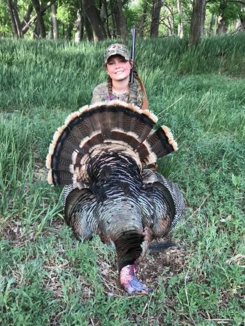 Hope Lacy 9 shows off a turkey that she killed with her dad last year. She enjoys hunting and feels that it is a way to have fun, but still do what you love. 
