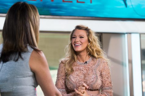 Pictured above is Blake Lively during an interview. She attended New York Fashion week and wore a baby blue power suit by Michael Kors at the Michael Kors show.